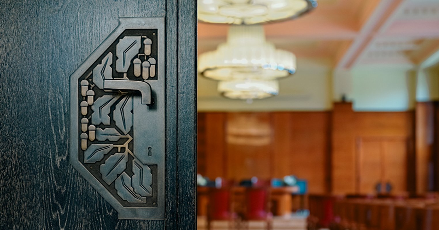 Poignée de porte avec des glands dans la maison communale de Forest © Korei Guided Tours